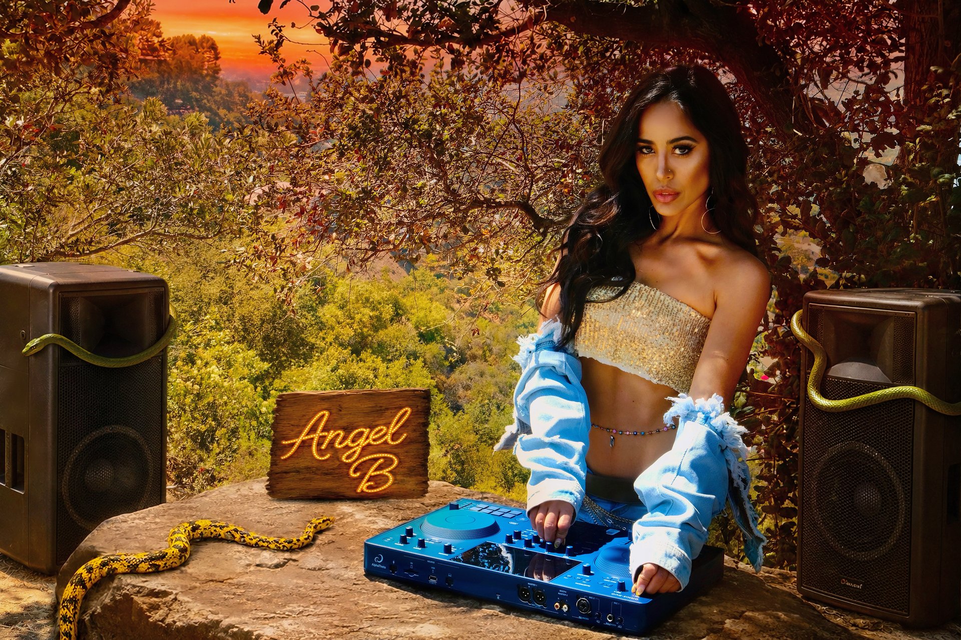 Angel B DJing outdoors with her controller